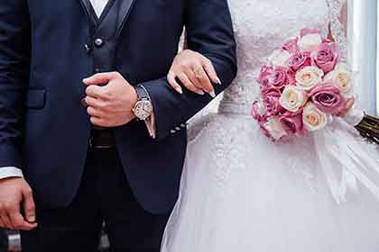 newlywed bride and groom lock arms